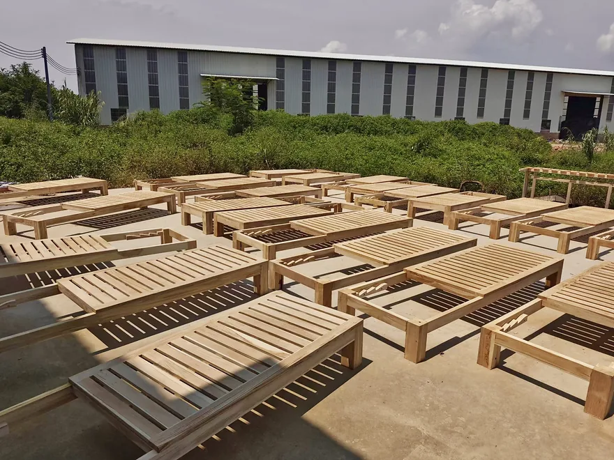Finished teak loungers in the KORDIA factory yard